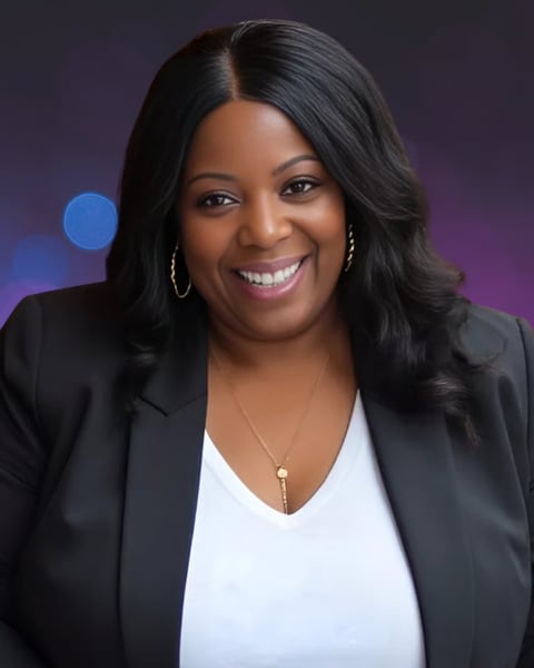 Professional portrait of a smiling woman with long black hair wearing a black blazer and white top against a purple gradient background